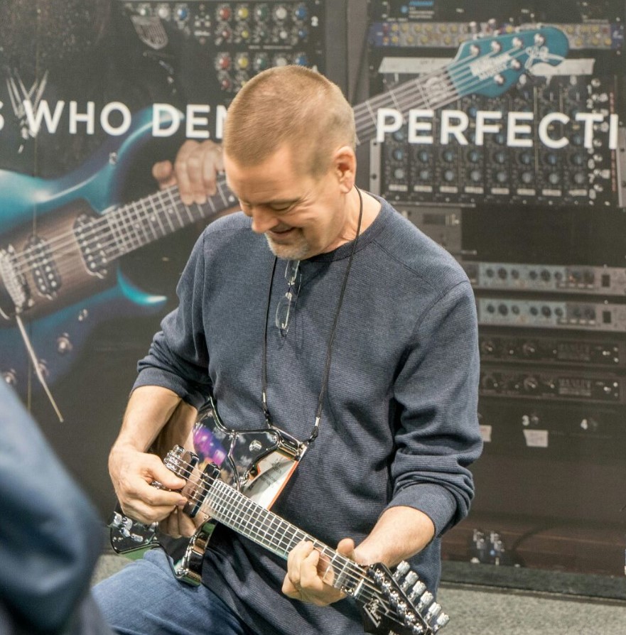 Tom Anderson tests an Aluminum guitar